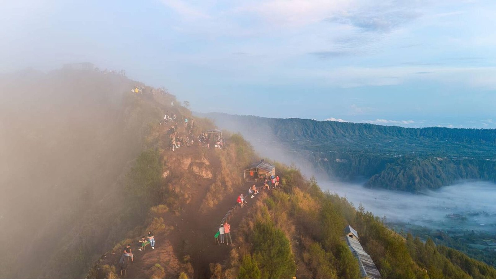 Hikers watching sunrise from Mount Batur summit in Bali