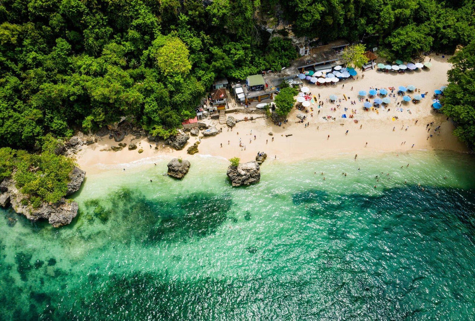 Surfers riding waves at Padang Padang Beach in Bali
