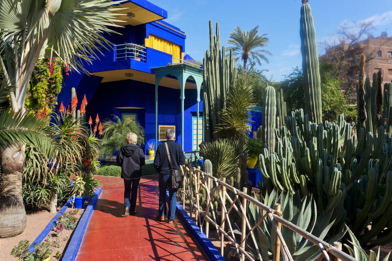 Vibrant blue structures and lush greenery at Majorelle Garden, Marrakech, Morocco