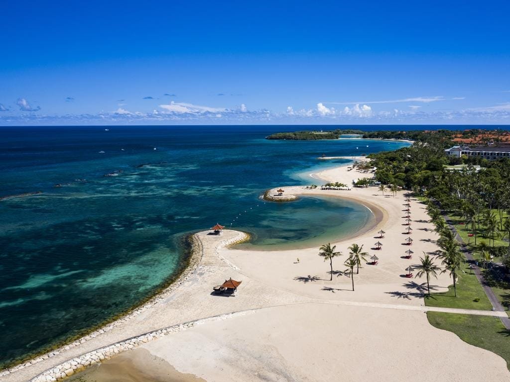 Turquoise waters and white sand at Nusa Dua Beach in Bali.