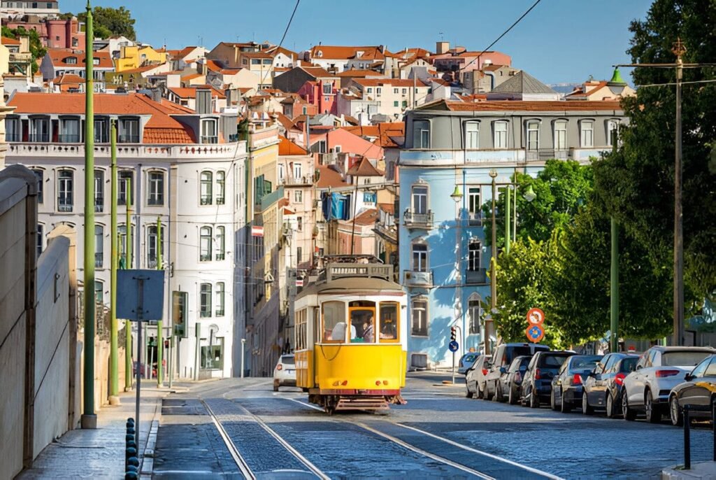 A colorful tram winding through Lisbon's streets with yellow buildings in the background